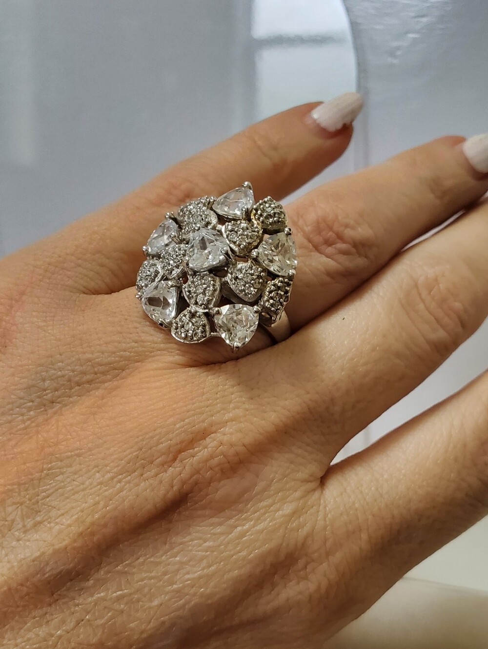 Sterling Silver dome ring featuring a large cluster of cubic zirconia stones.